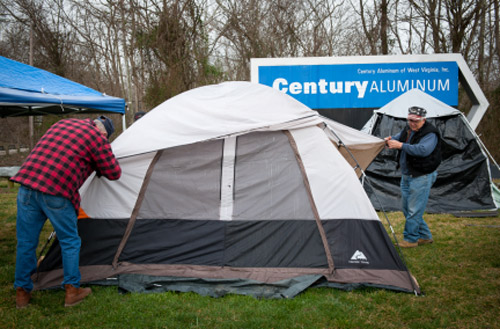 After 75 days of camping out in front of the Century Aluminum facility and finally reaching what they thought was a good agreement with the company, the retirees broke camp and ended their protest. Retirees Bob Blare, 75 (left) and Roy Dailey, 76 (right), begin the process of tearing down tents at the camp. 
