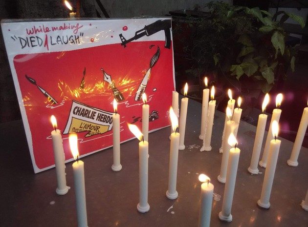  Indian journalists and cartoonists protested and expressed solidarity with victims of attack on a Paris-based media house "Charlie Hebdo" by drawing their creations and lighting candles in New Delhi, main visual by Cartoonist Shekhar Gurera Photo by Pk4wp